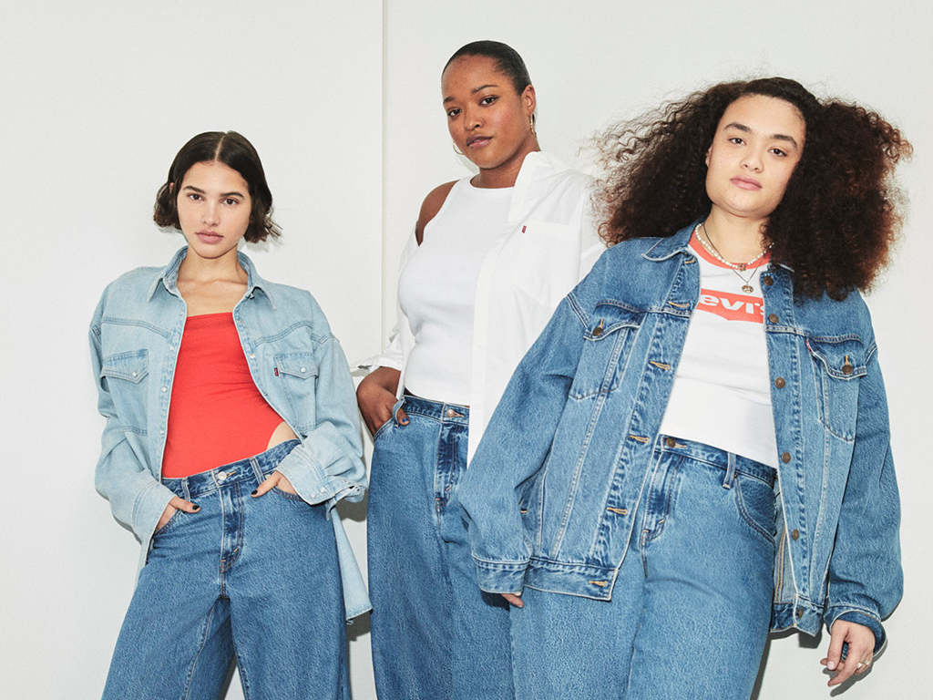 three female models displaying levi's jeans