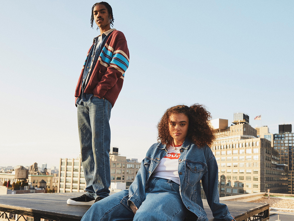 2 models on roof of building display levi's products