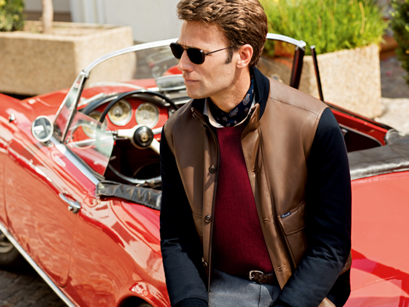male model lean on vintage car wearing his clothes from rodeo