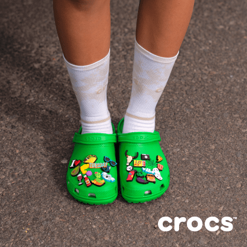 Kid wearing green crocs
